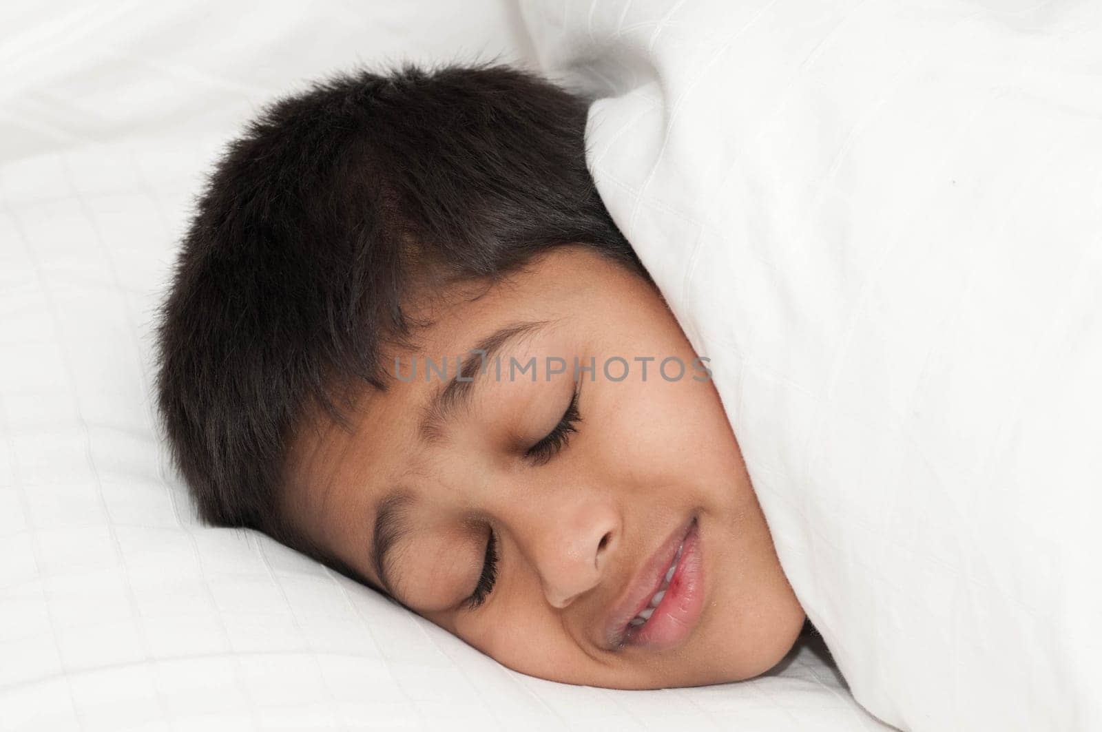 A handsome indian kid smiling for you