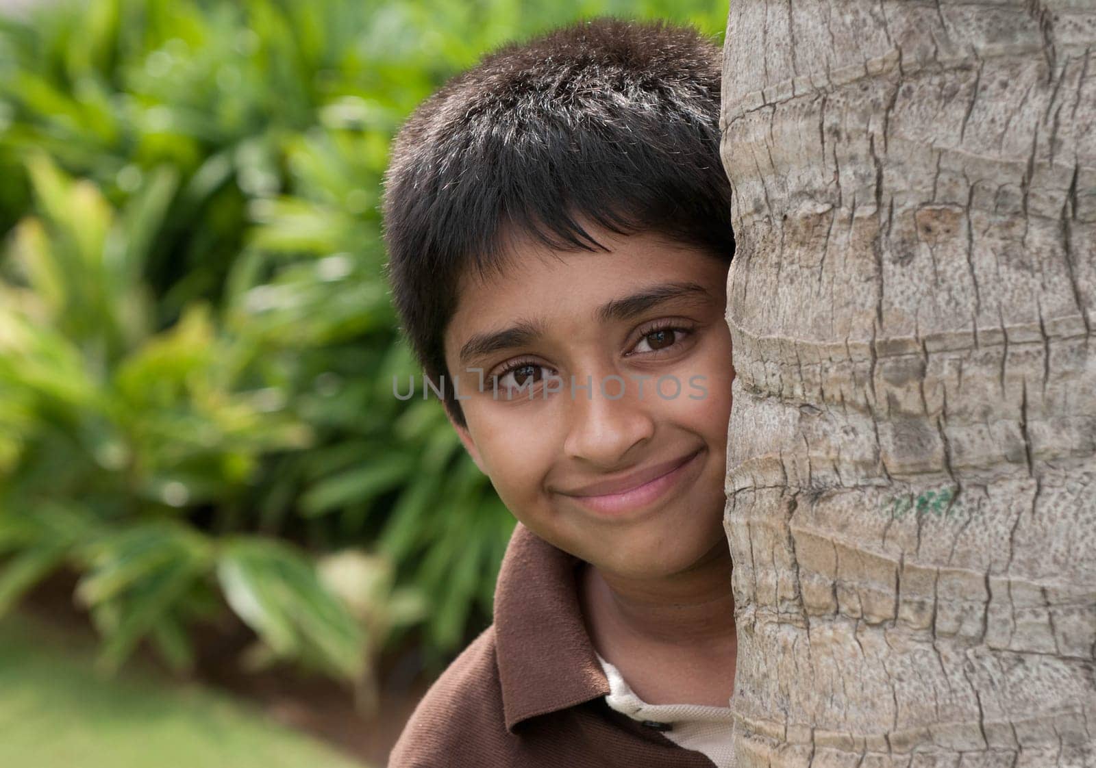 An handsome Indian kid peeping thru the trunk