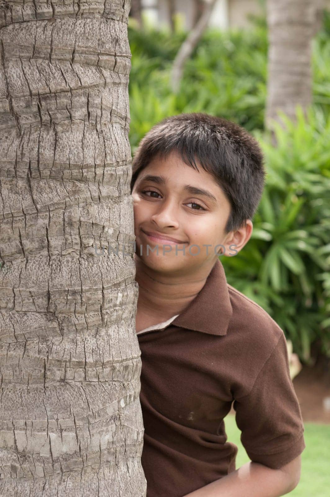 An handsome Indian kid peeping thru the trunk