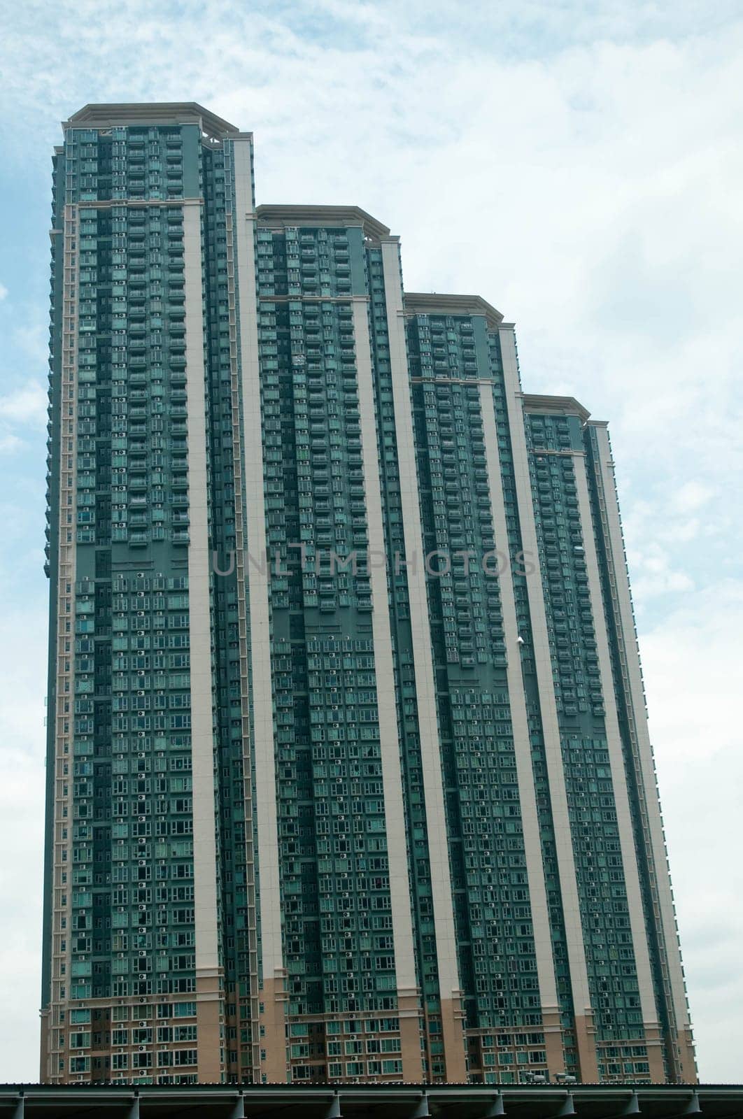 Tall residential apartments touching the blue  sky
