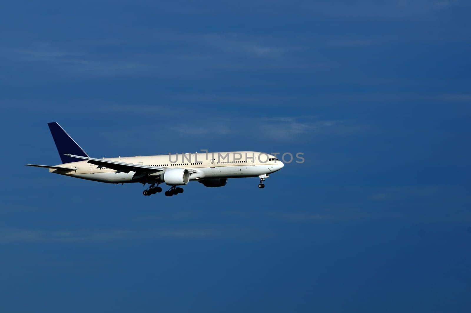 An aeroplane with landing gears switched on and ready to land