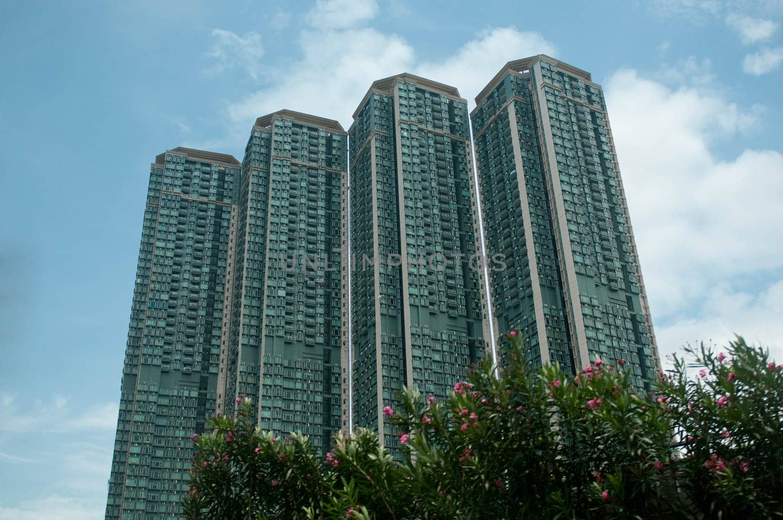 Tall residential apartments touching the blue  sky