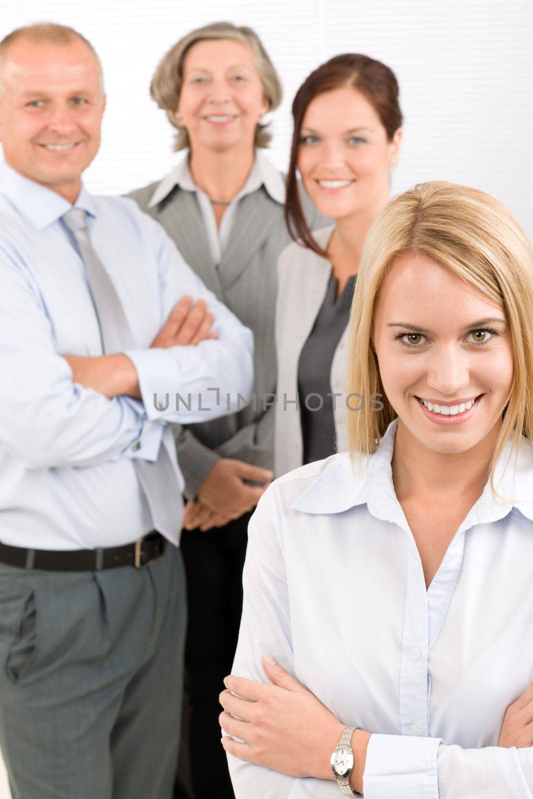 Business team attractive young businesswoman with happy mature colleagues