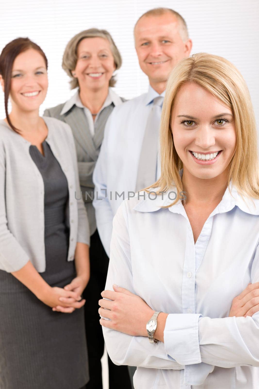 Business team attractive young businesswoman with happy mature colleagues