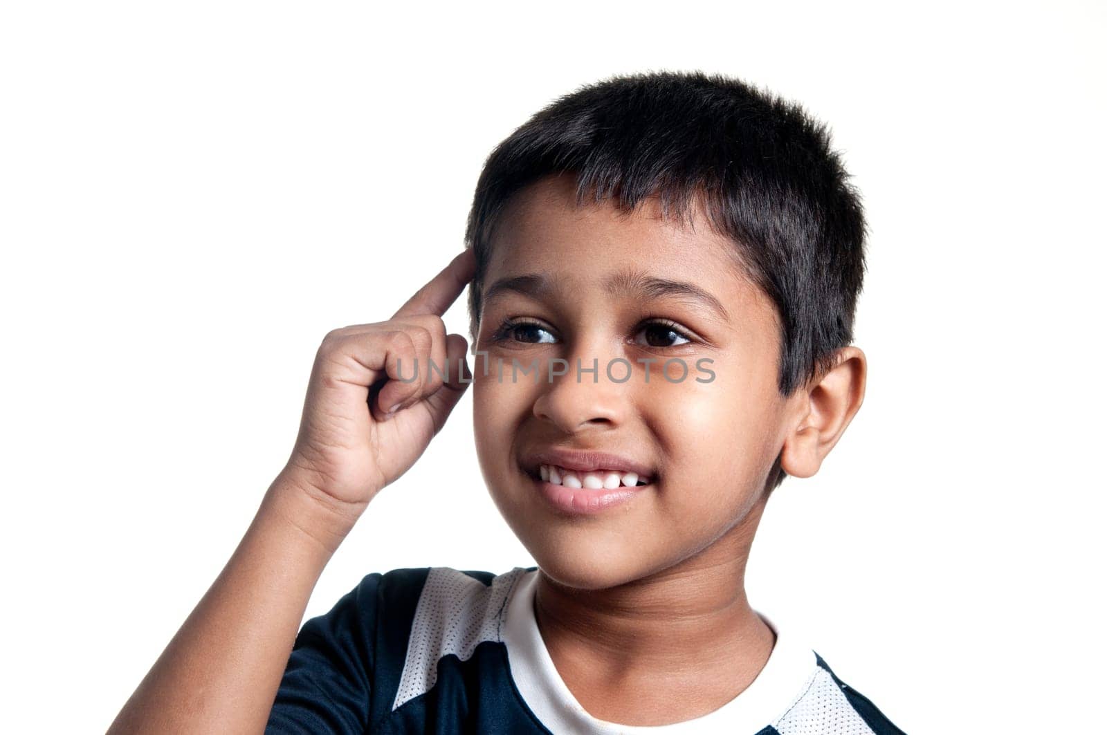 an handsome young indian kid thinking about something