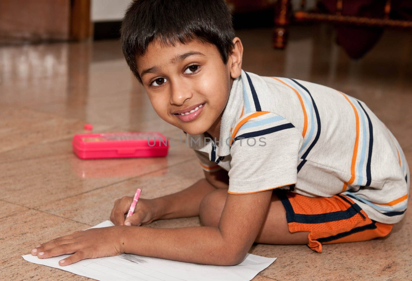 an handsome indian kid doing homework