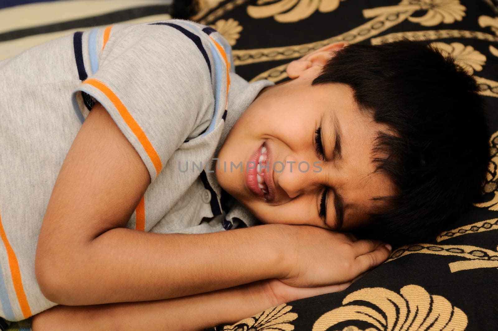An handsome Indian kid sleeping very happily