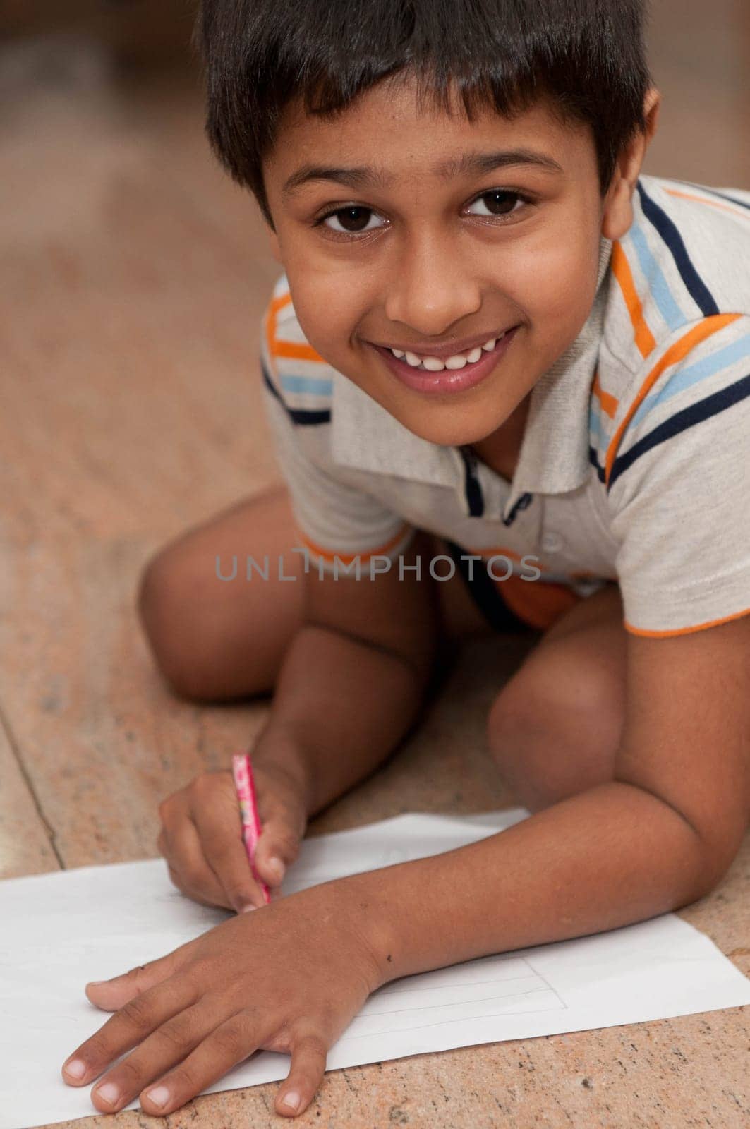 an handsome indian kid doing homework