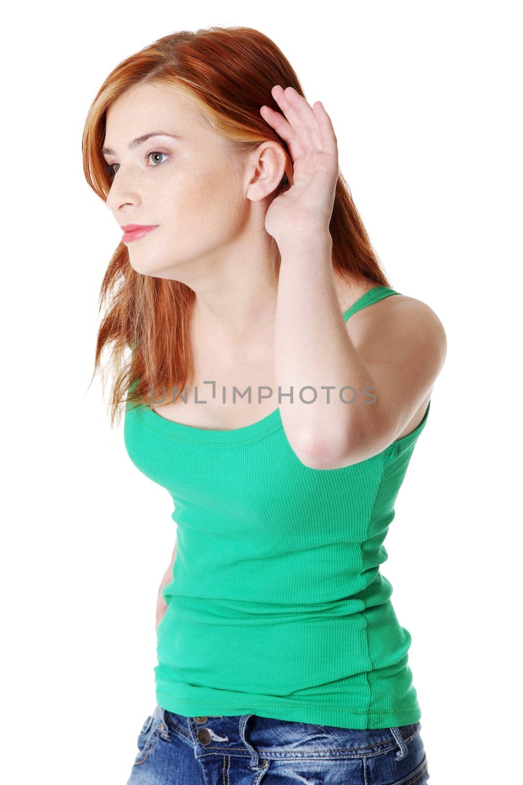 Young beautiful caucasian girl listening you. Isolated on white