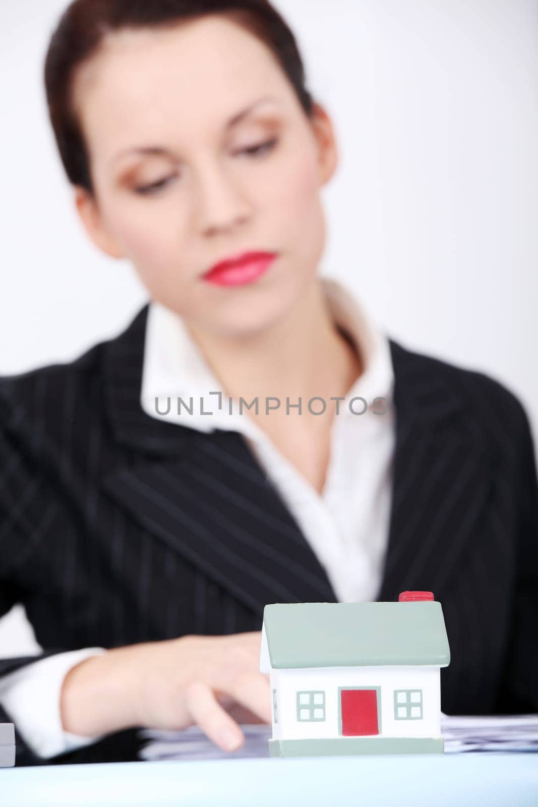 Closeup on little house in businesswoman`s office.