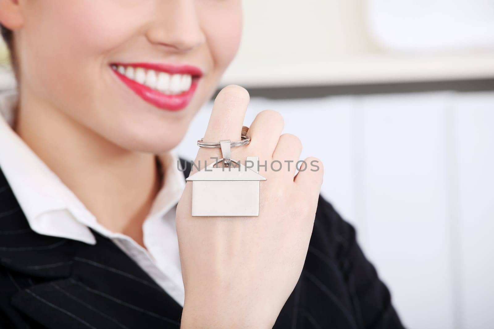 Closeup on key breloque on woman`s palm