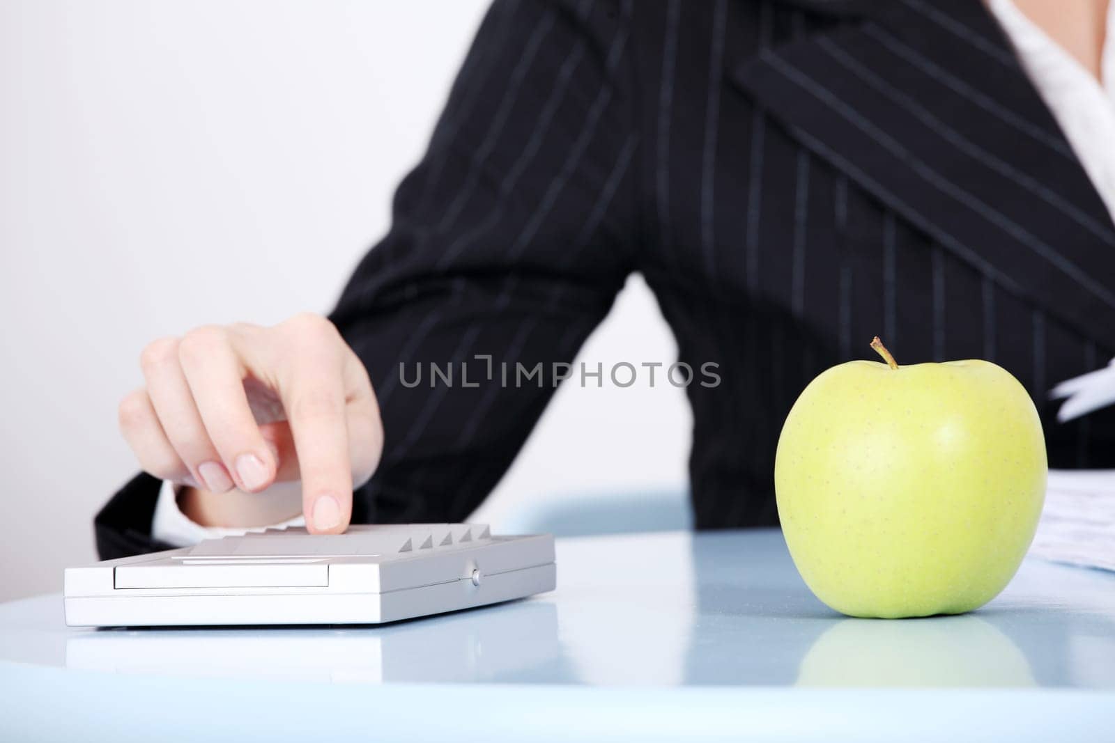 Closeup on green apple lying in the office.