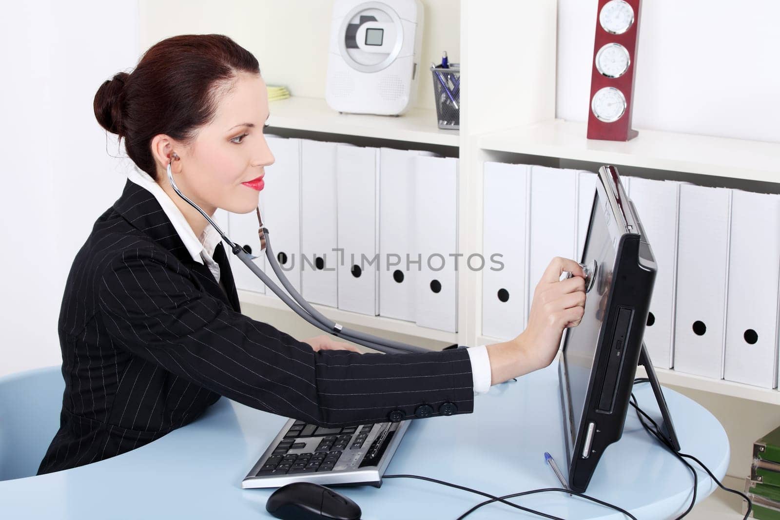 Pretty caucasian businesswoman examinig monitor in the office.
