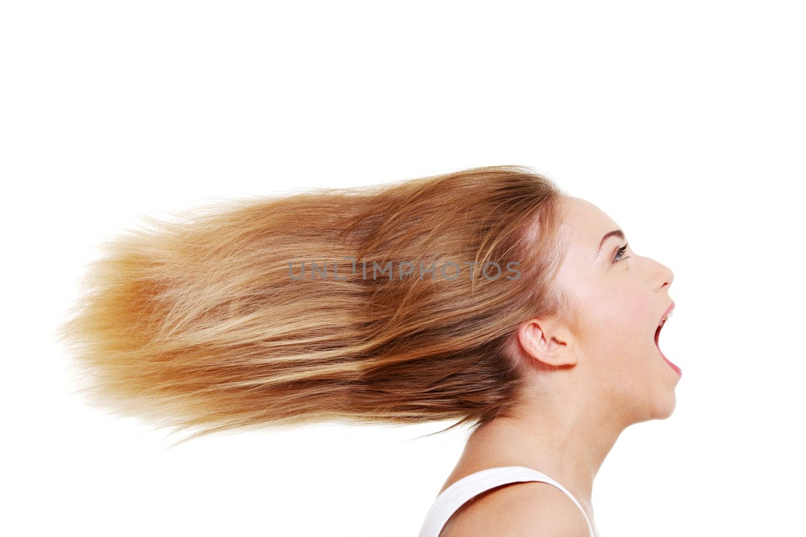 Teen beautiful caucasian woman with blond hairs screaming.