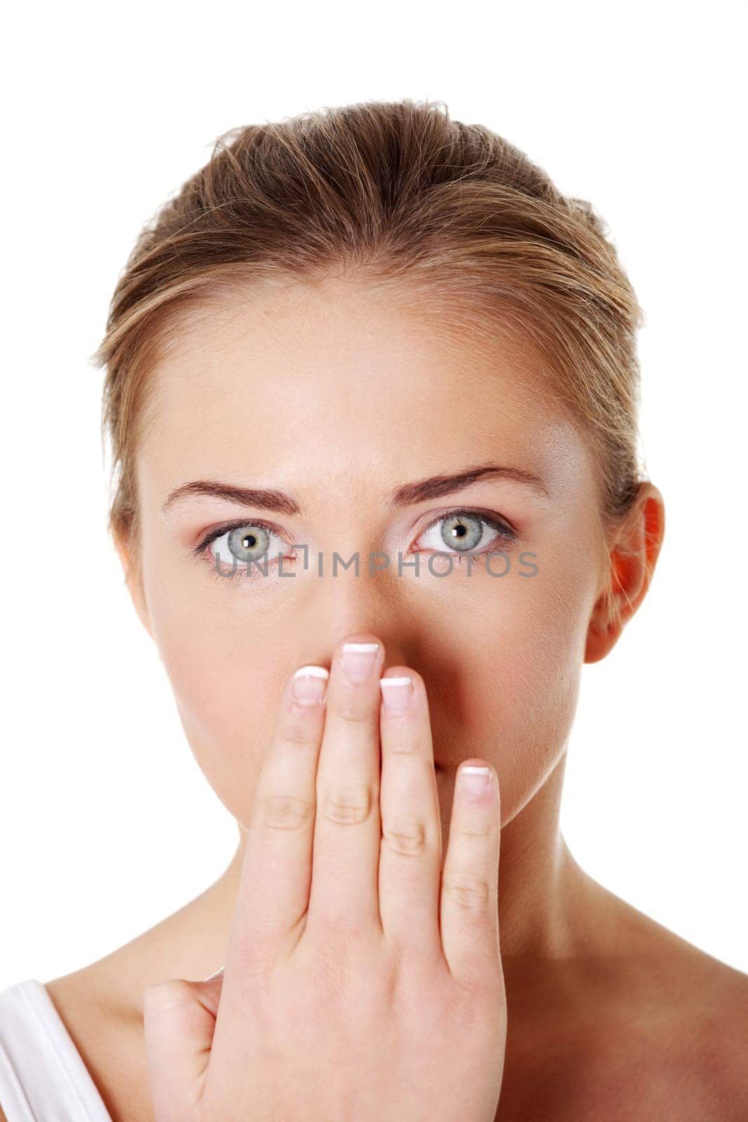 Close up portrait of young woman covering her mouth with hand