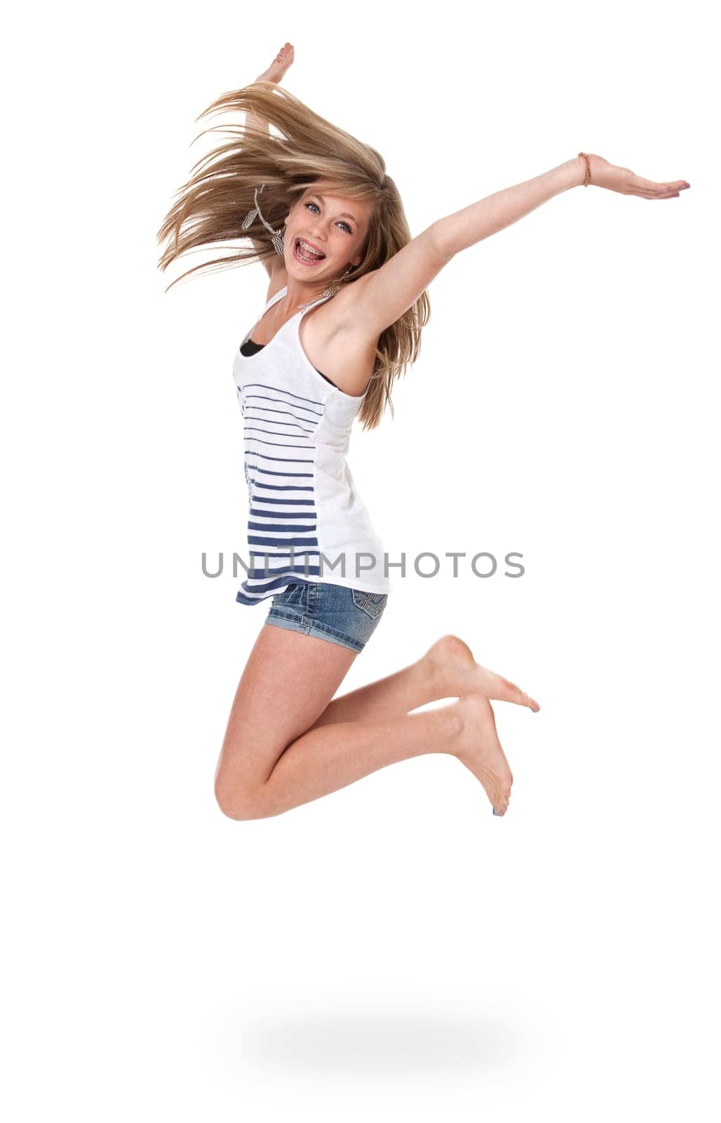 Pretty 14 year old girl jumping mid-air, isolated on white.