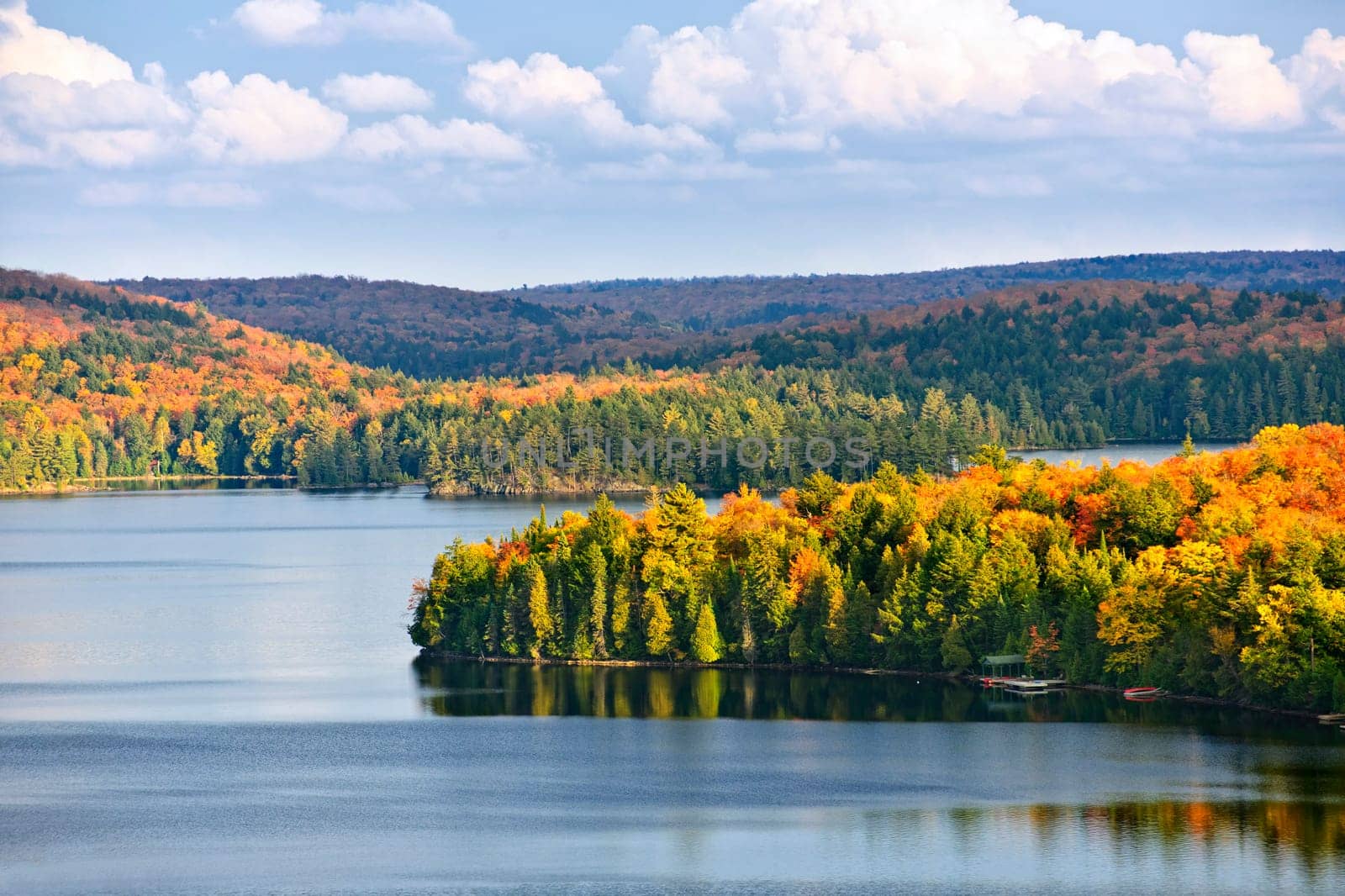 Fall forest of colorful autumn trees on islands in calm lake