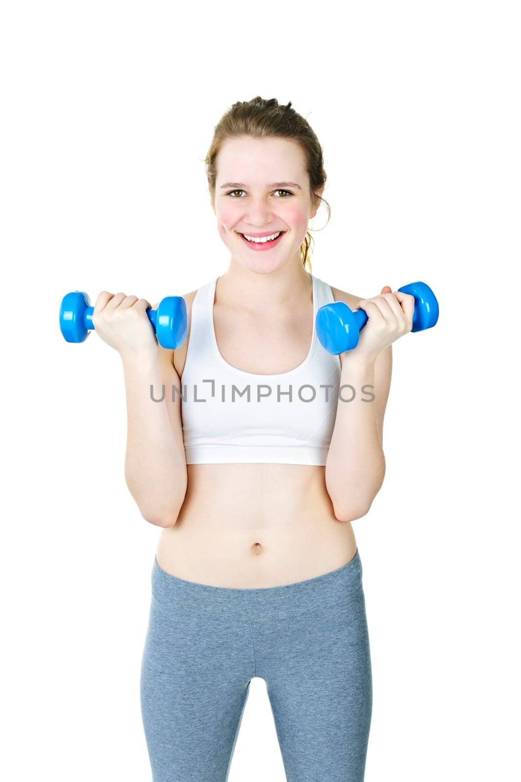 Happy fit young woman working out with weights on white background