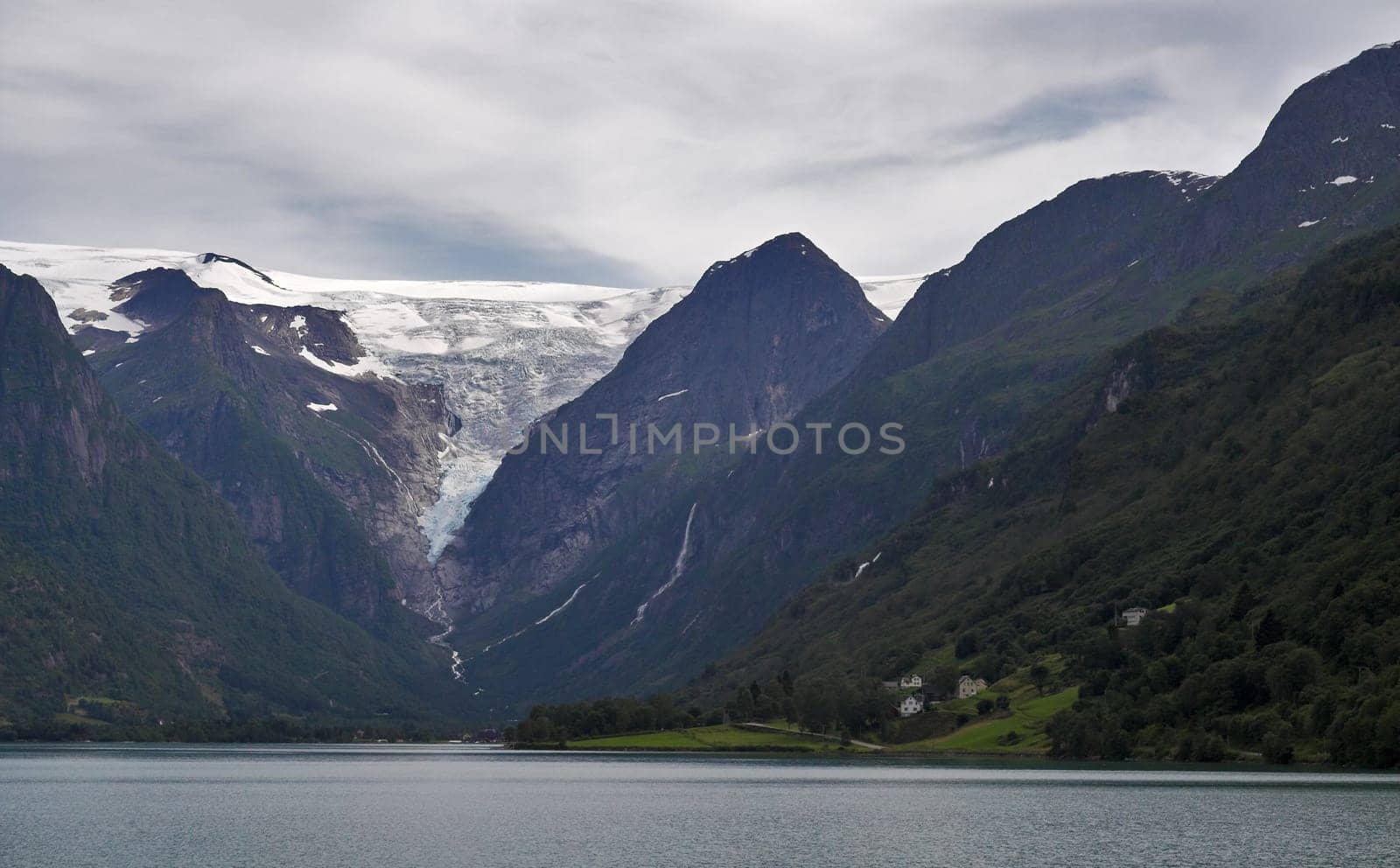 View at mountains and Briksdal glacier above the lake. Norway.