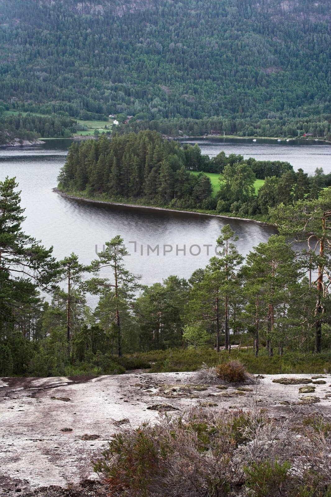Seljord lake, Norway  surrounded by mountains and woods  village on the far side of the lake.
