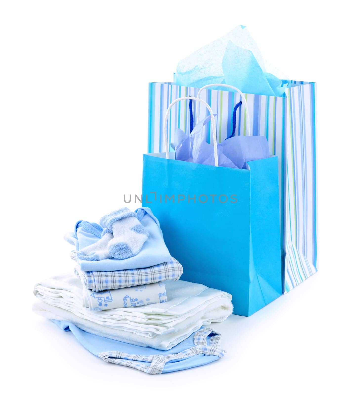 Gift bags and infant clothes for baby shower isolated on white