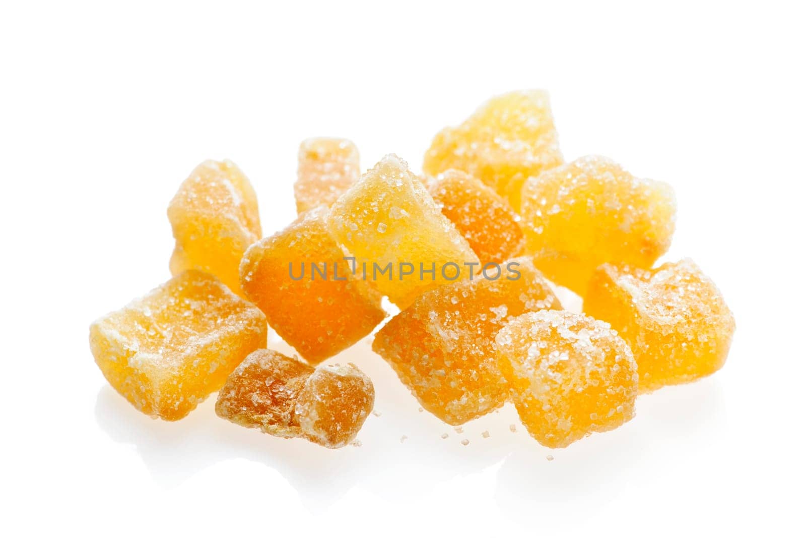 Caramelized ginger candy pieces isolated on white background