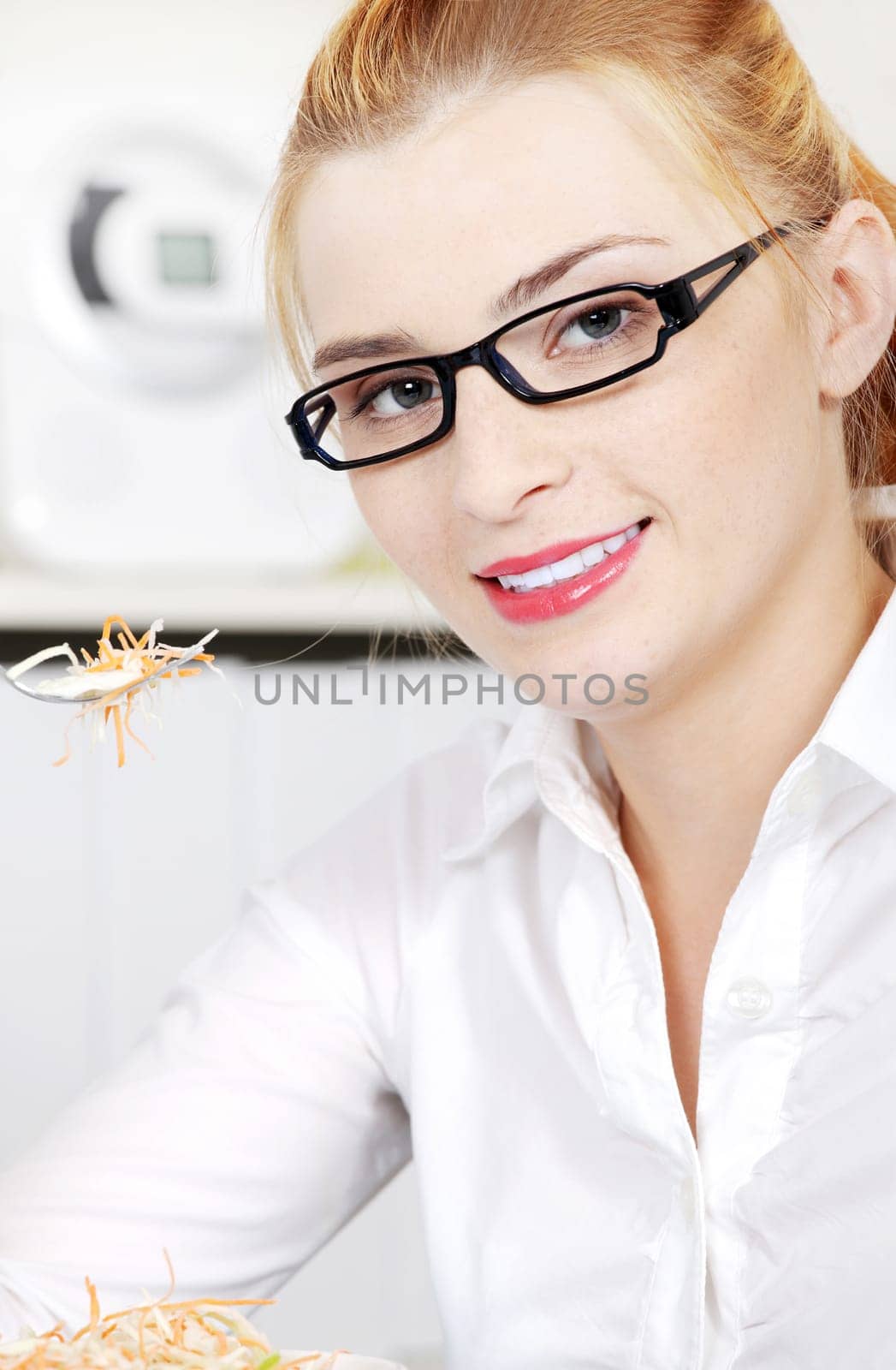 Closeup portrait on woman eating her salad in the office.