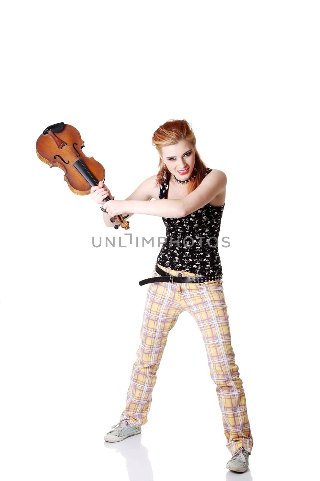 Angry punk girl intending to break her fiddle. Isolated on white.