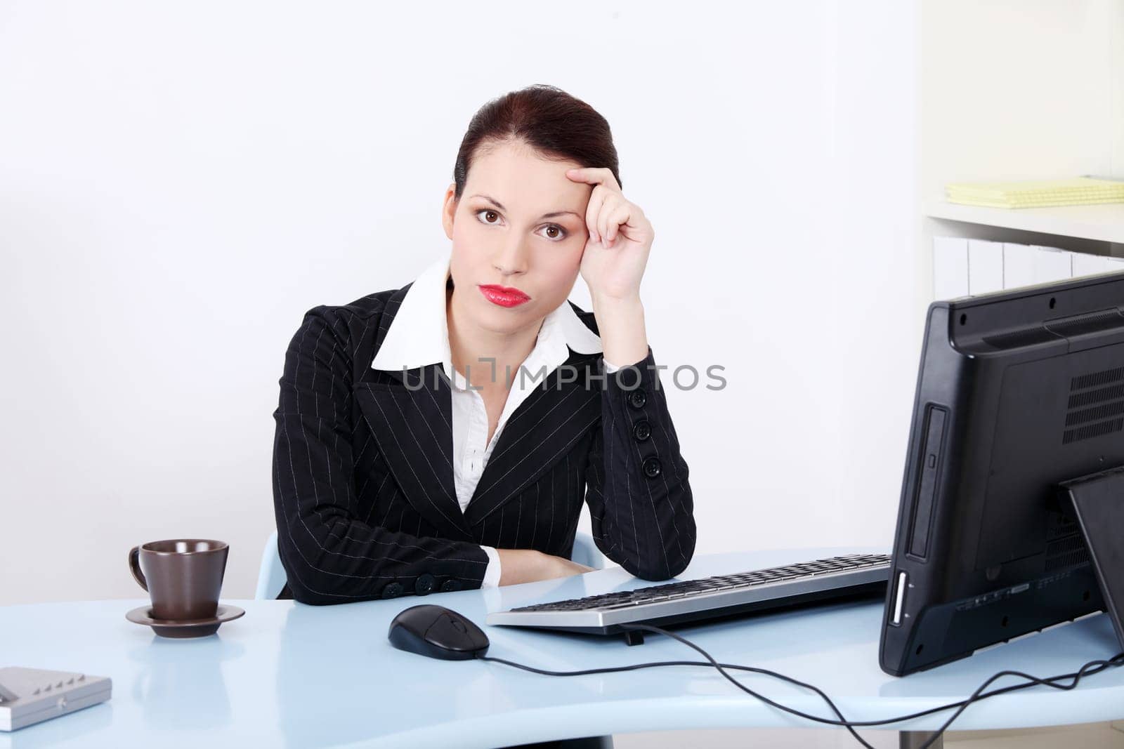 Pretty caucasian tired businesswoman sitting in the office.