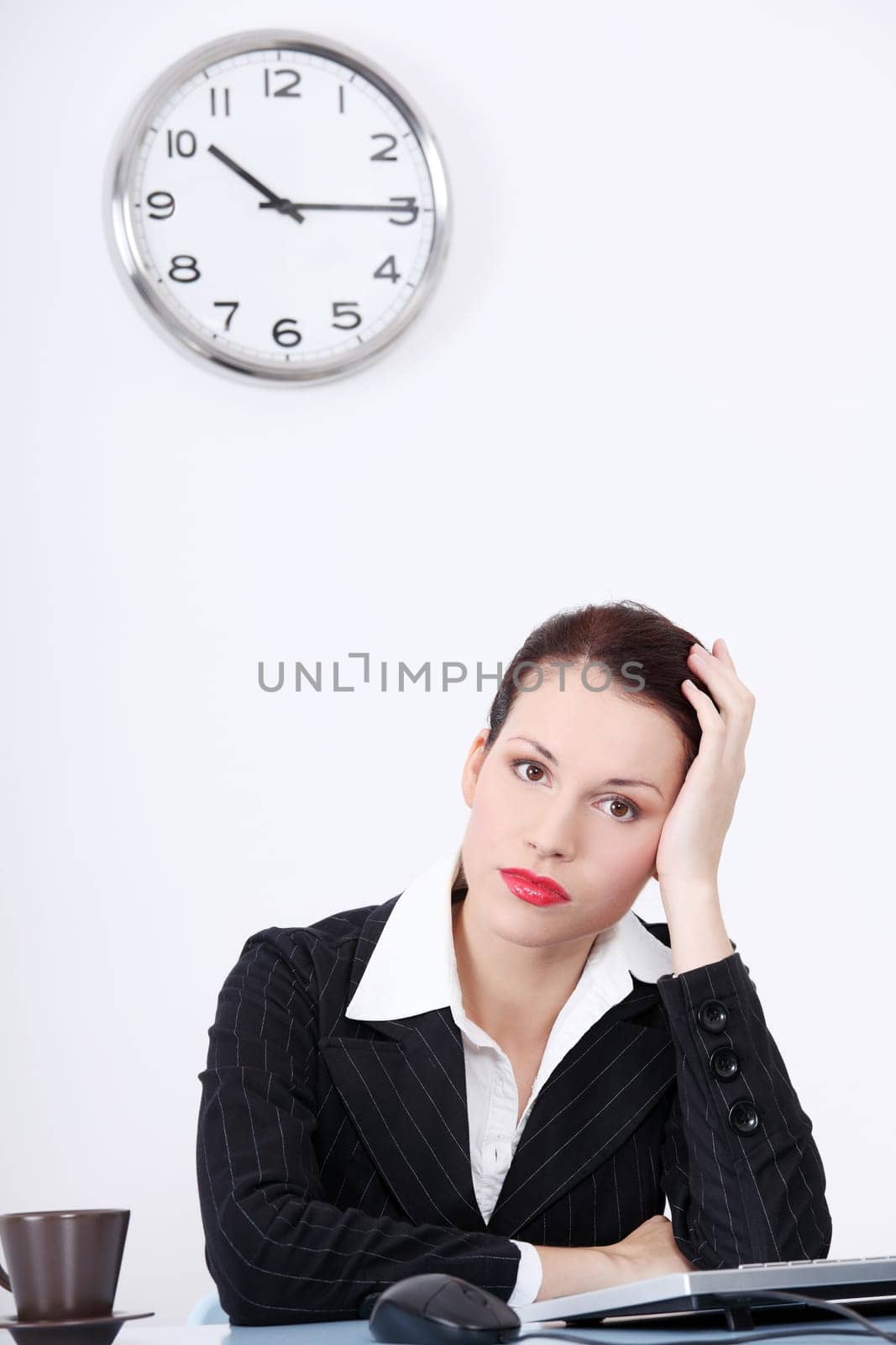 Pretty caucasian tired businesswoman sitting in the office.