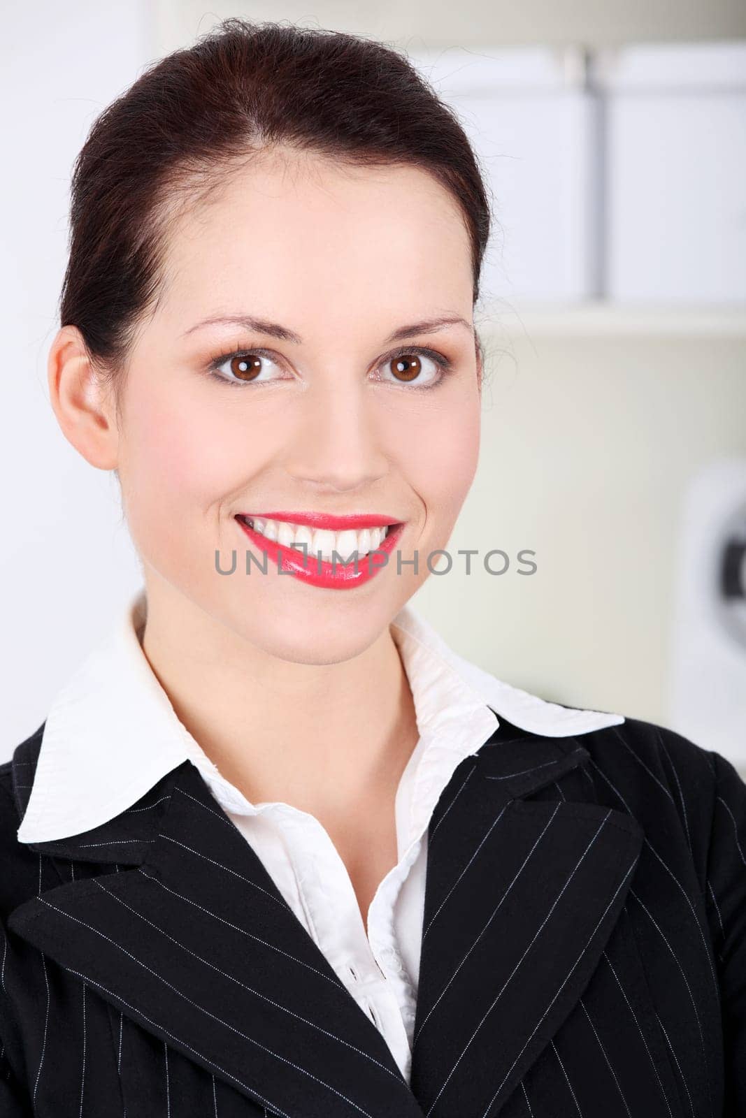 Closeup on pretty caucasian smiling businesswoman`s face.