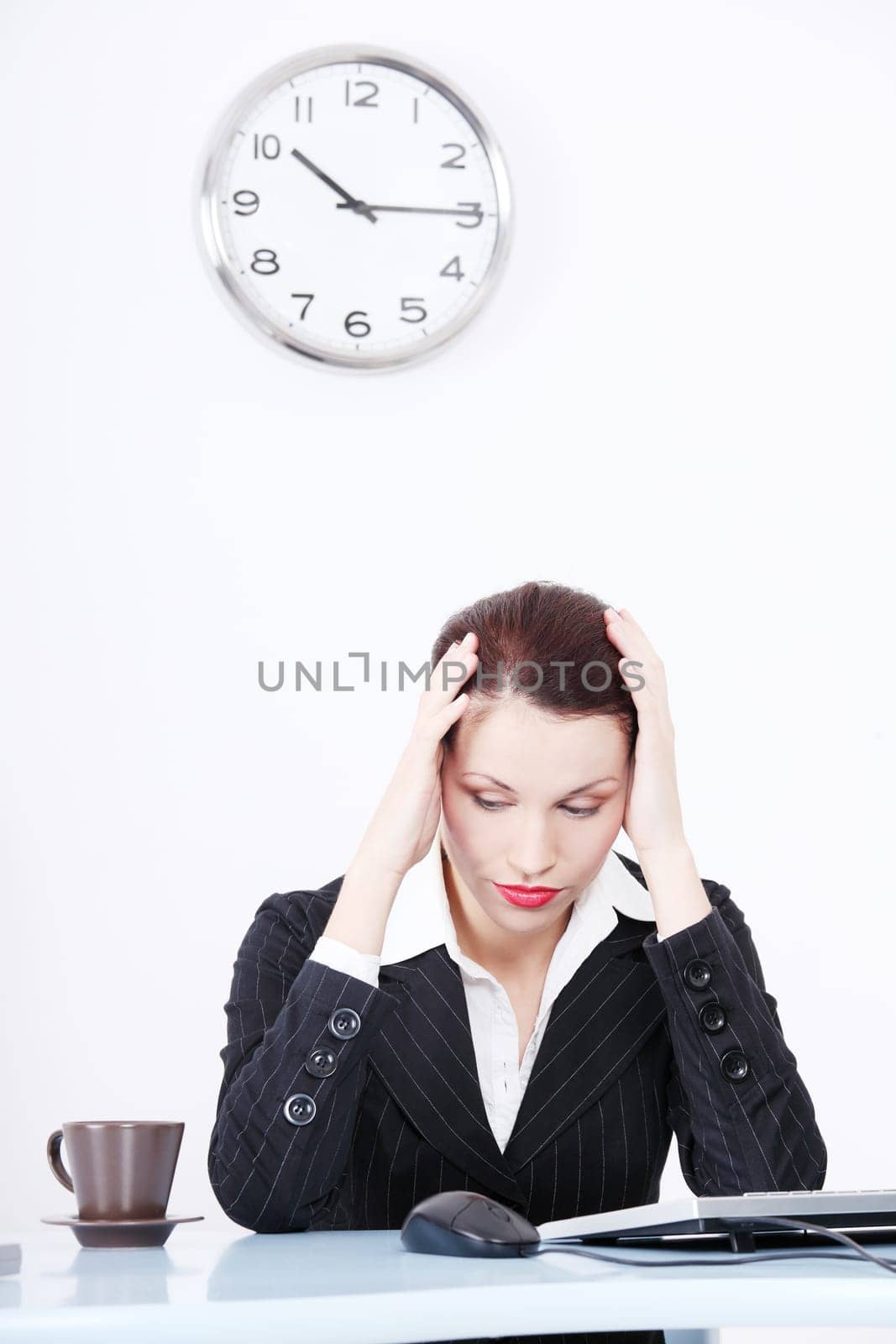 Pretty caucasian tired businesswoman sitting in the office.
