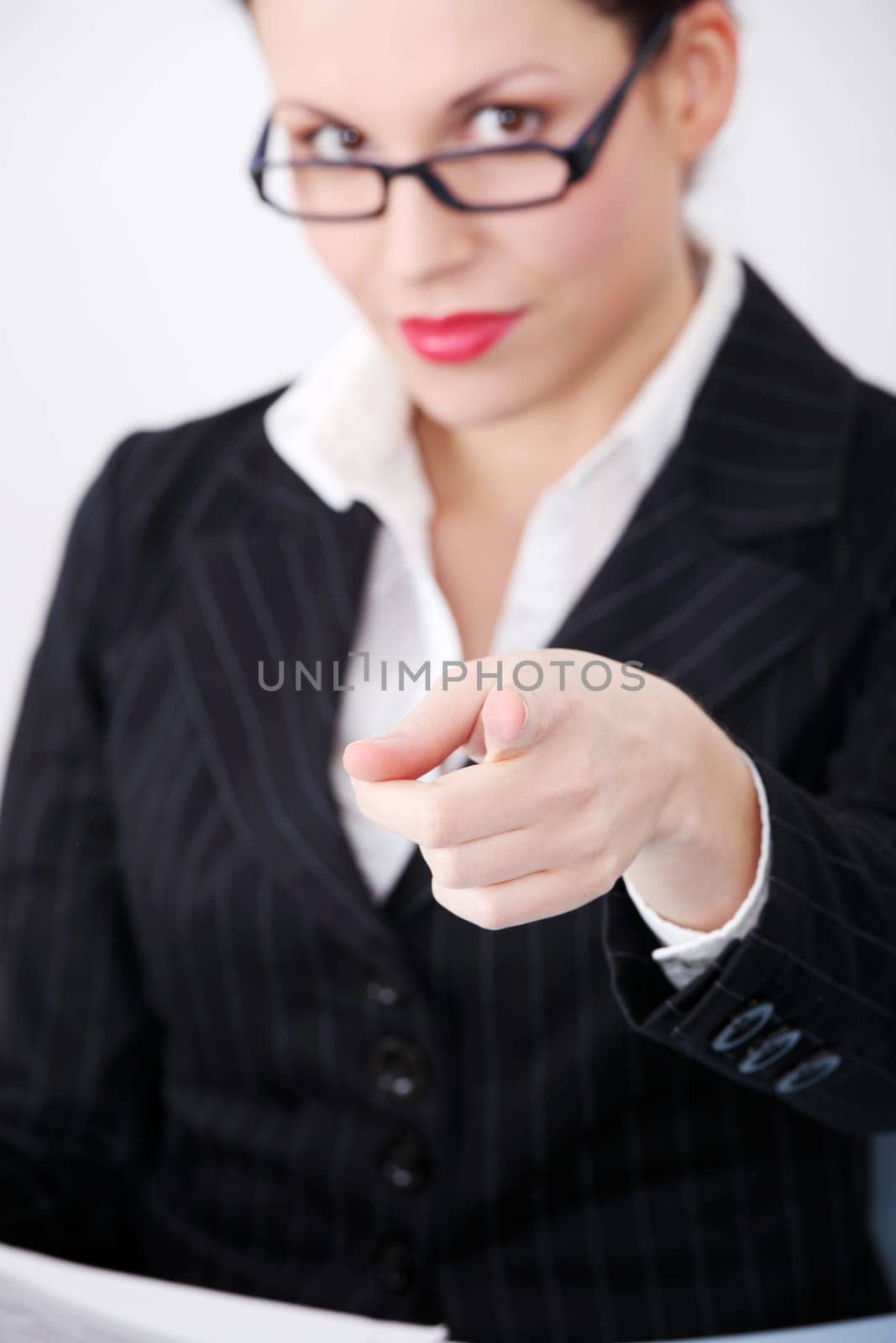 Pretty caucasian businesswoman pointing on you.
