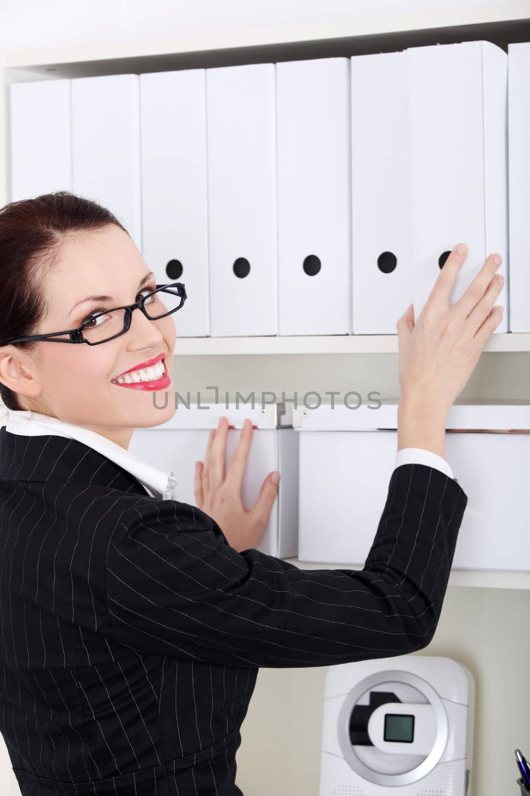 Pretty caucasian standing businesswoman holding file binder.