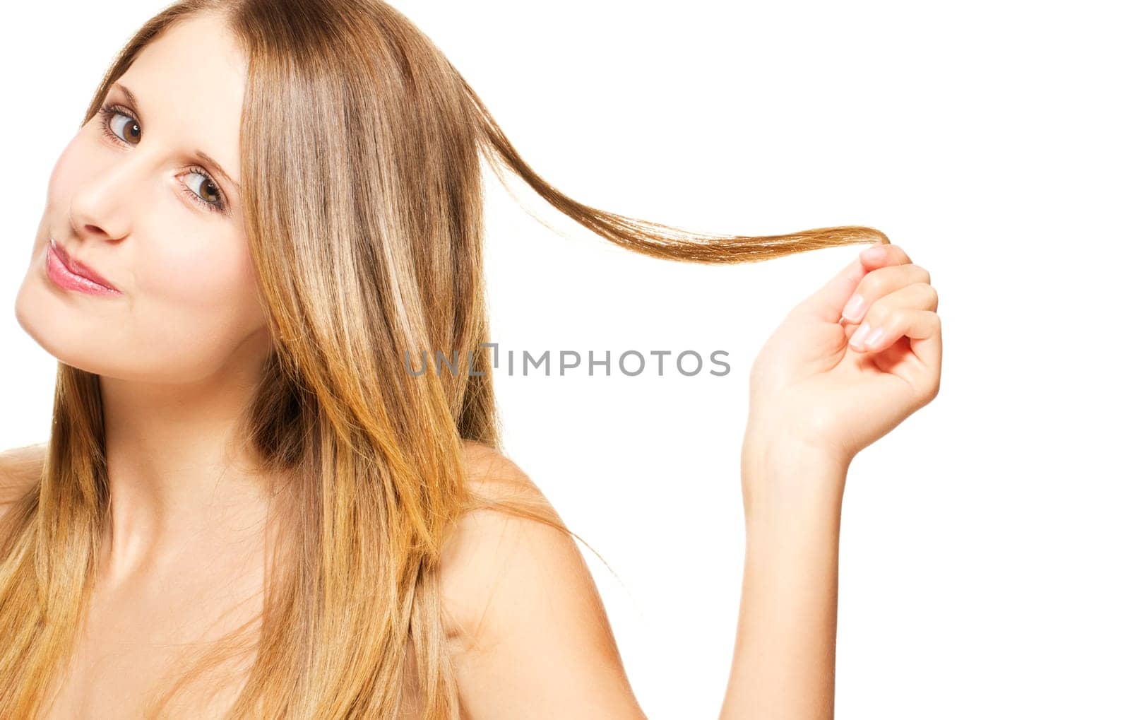 Young mischievous woman playing with her hair on white background