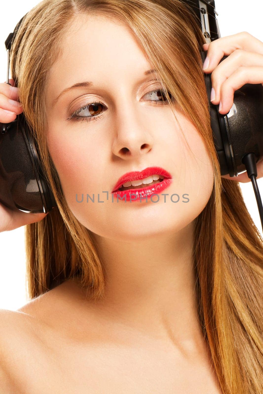Young blonde woman with headphones listening to music