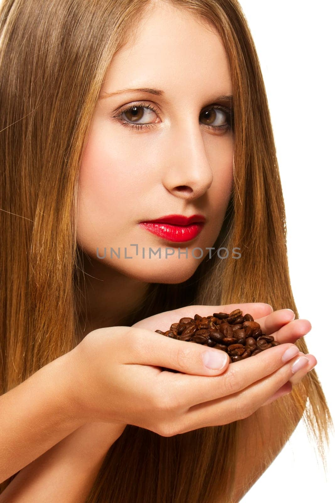 Beautiful woman smelling coffee beans on white background