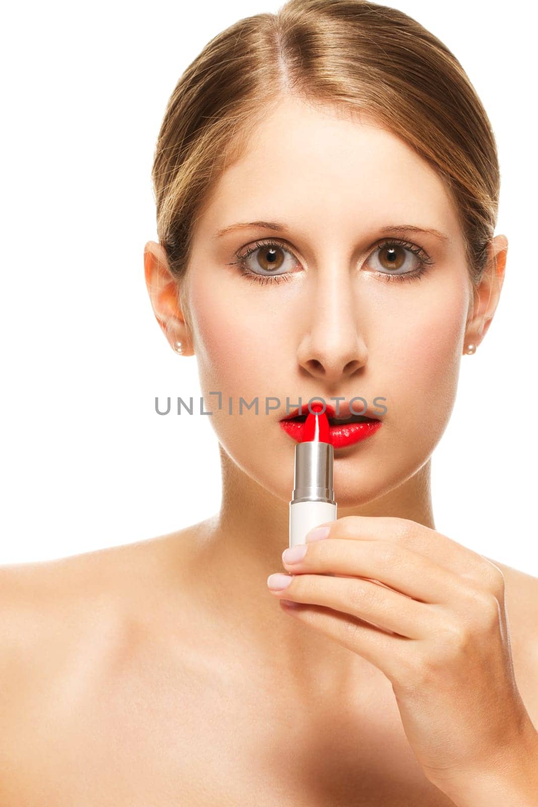 Young beautiful woman applying lipstick on against white background