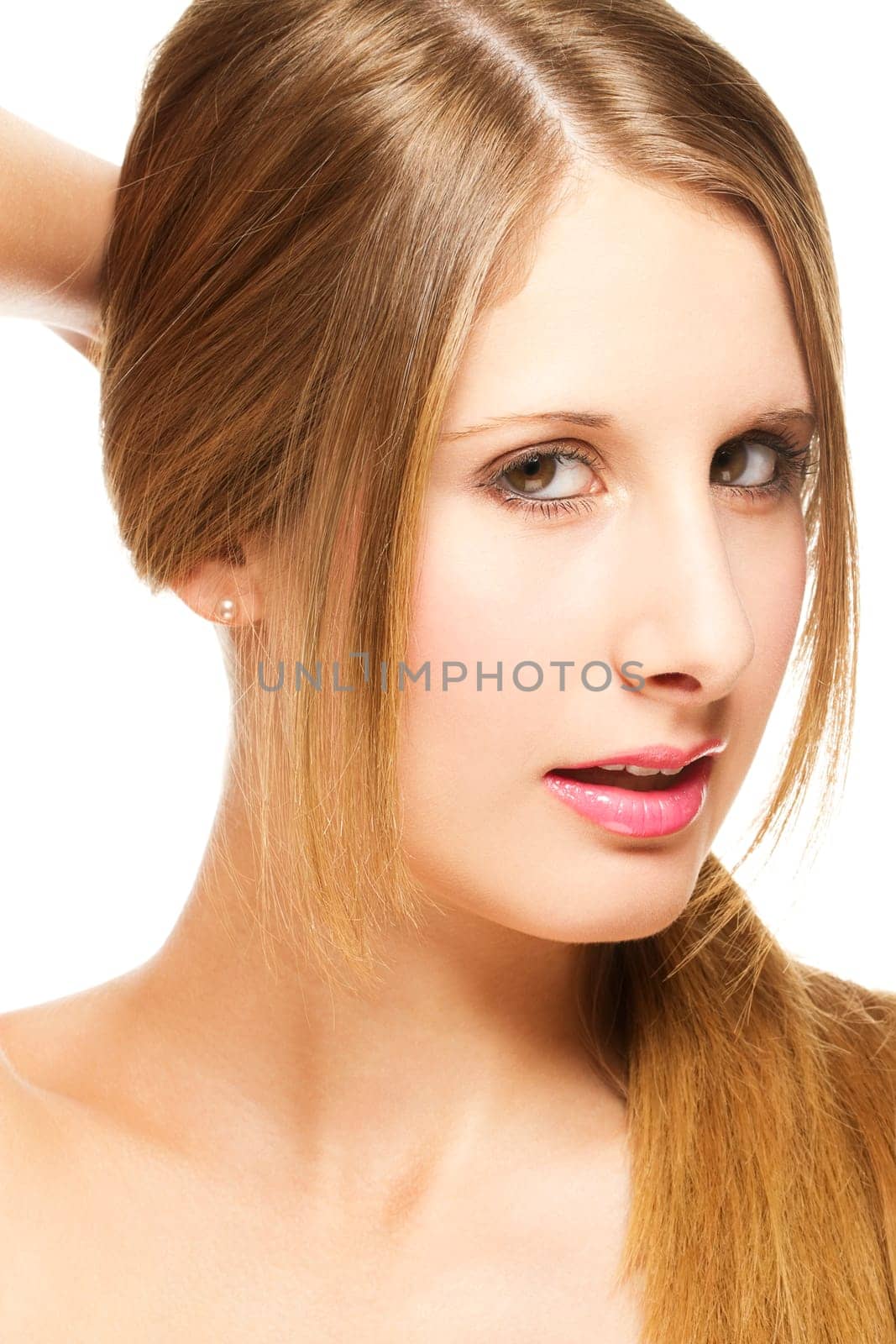Young blonde woman holding hair in a ponytail on white background