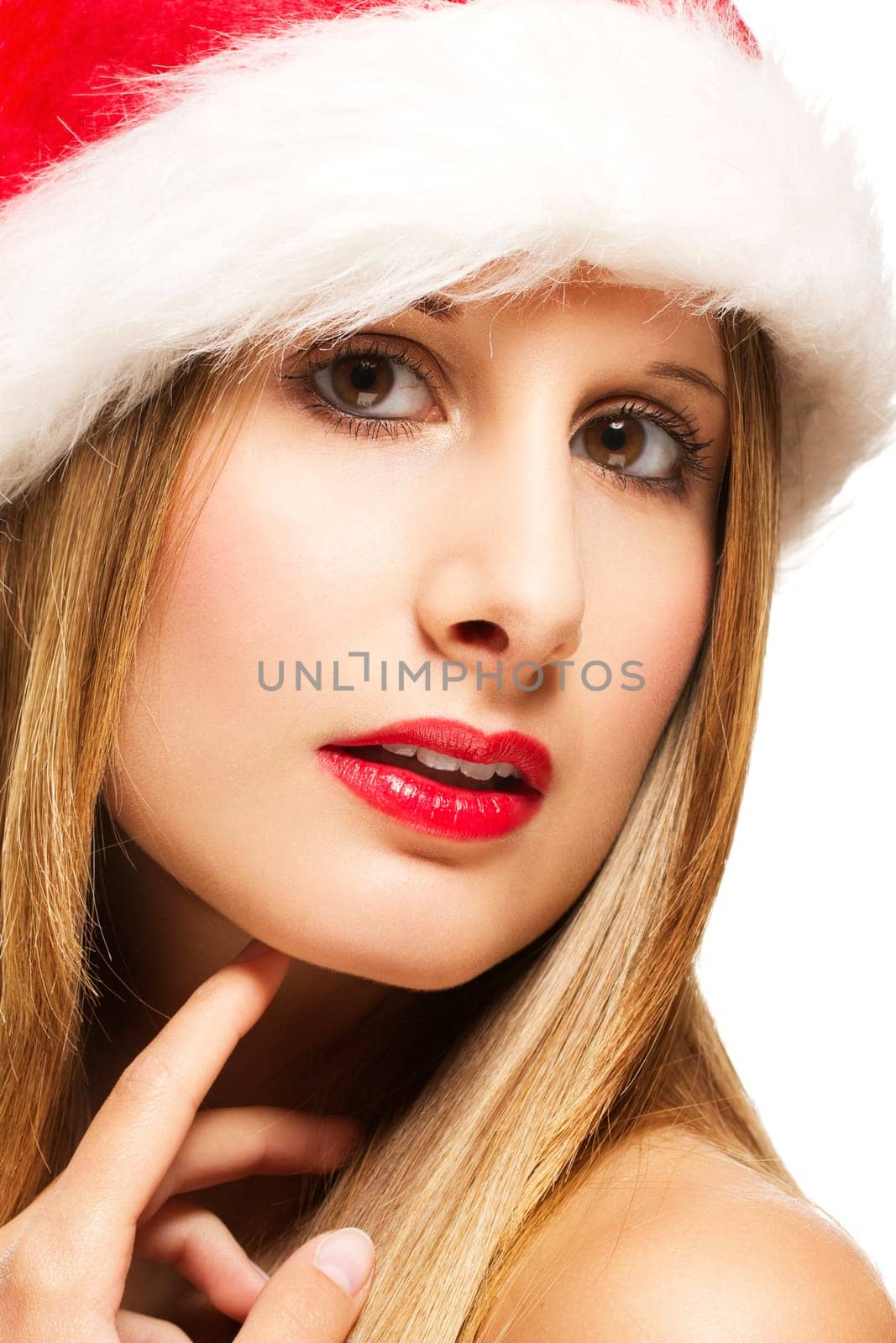 Close-up of a young beautiful woman wearing a Santa hat on a white background