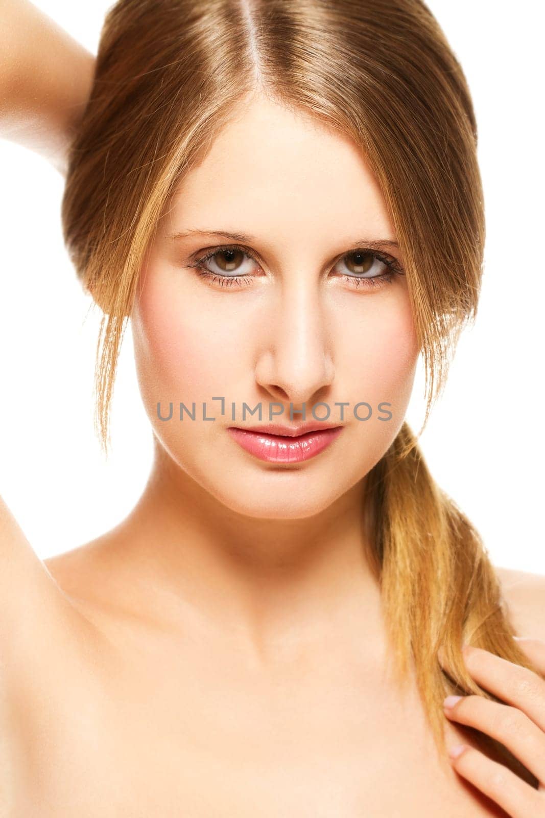 Young beautiful woman holding her hair on white background