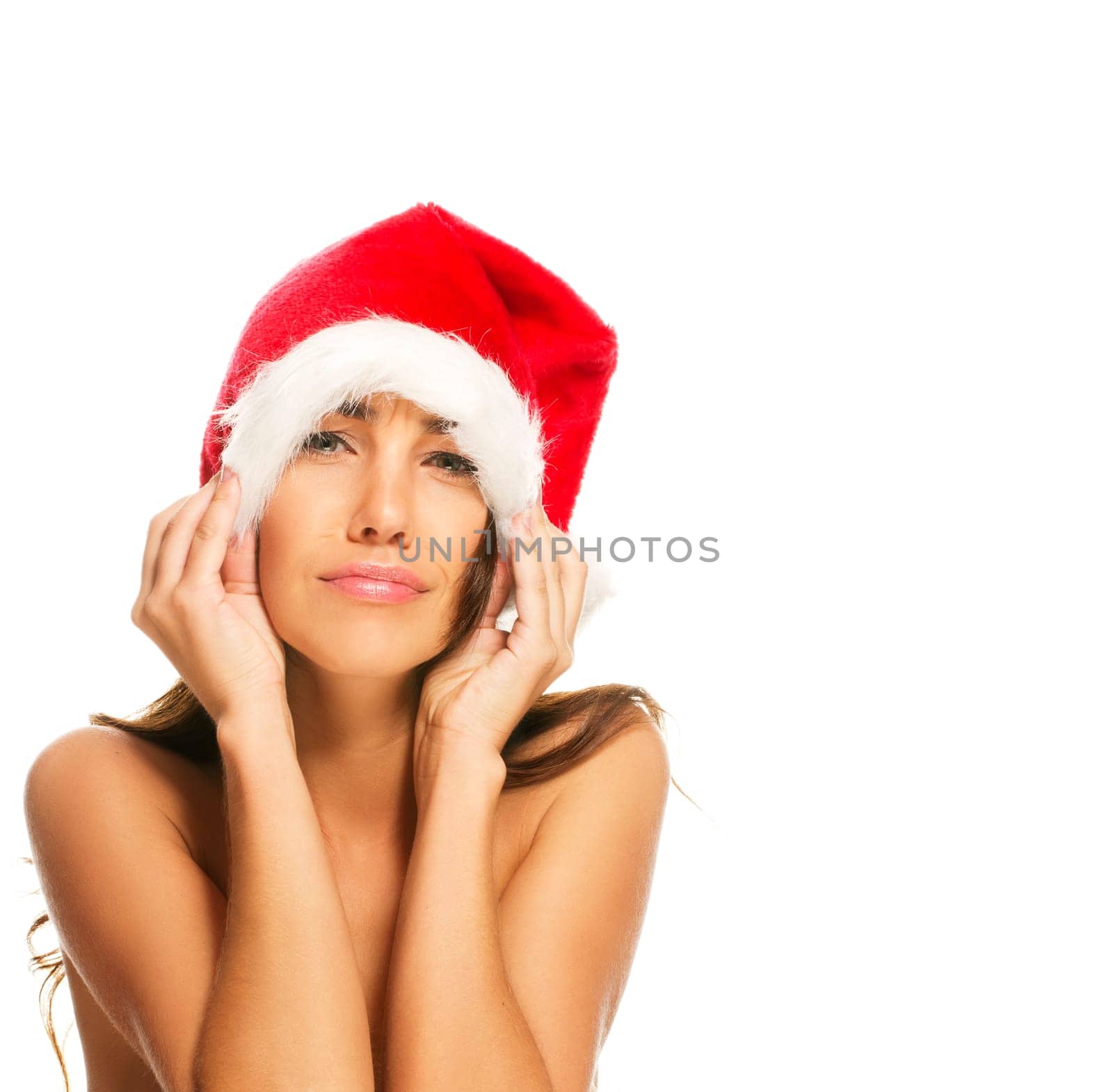Young woman in Santa hat making faces on white background