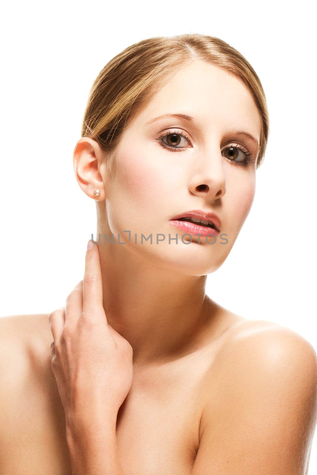 Young beautiful woman holding finger to neck on white background