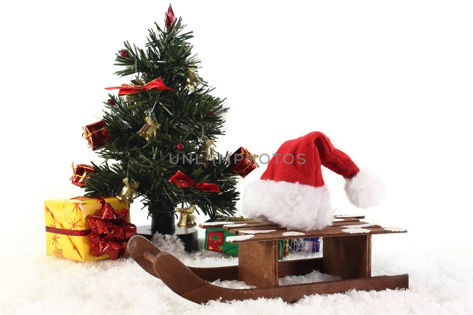 a sleigh with a Santa hat in the snow