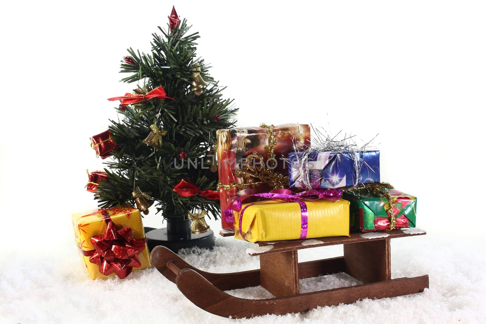 a sleigh with colorful gifts in the snow