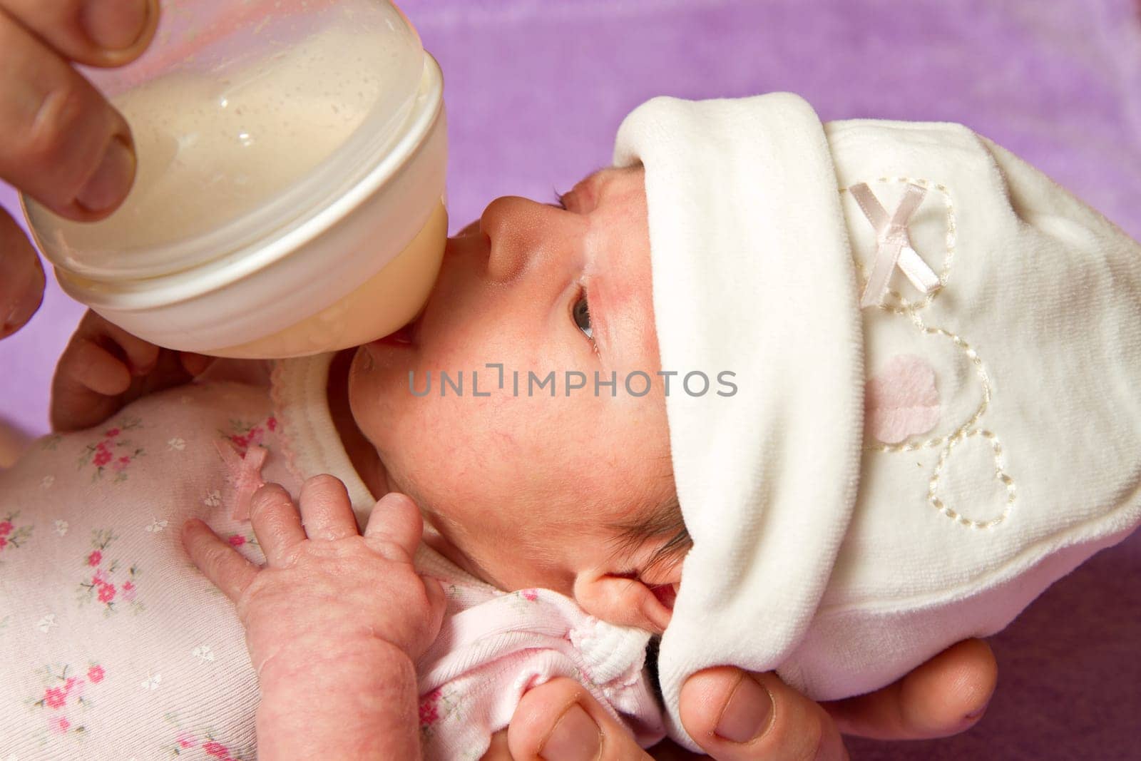 baby eating from a bottle