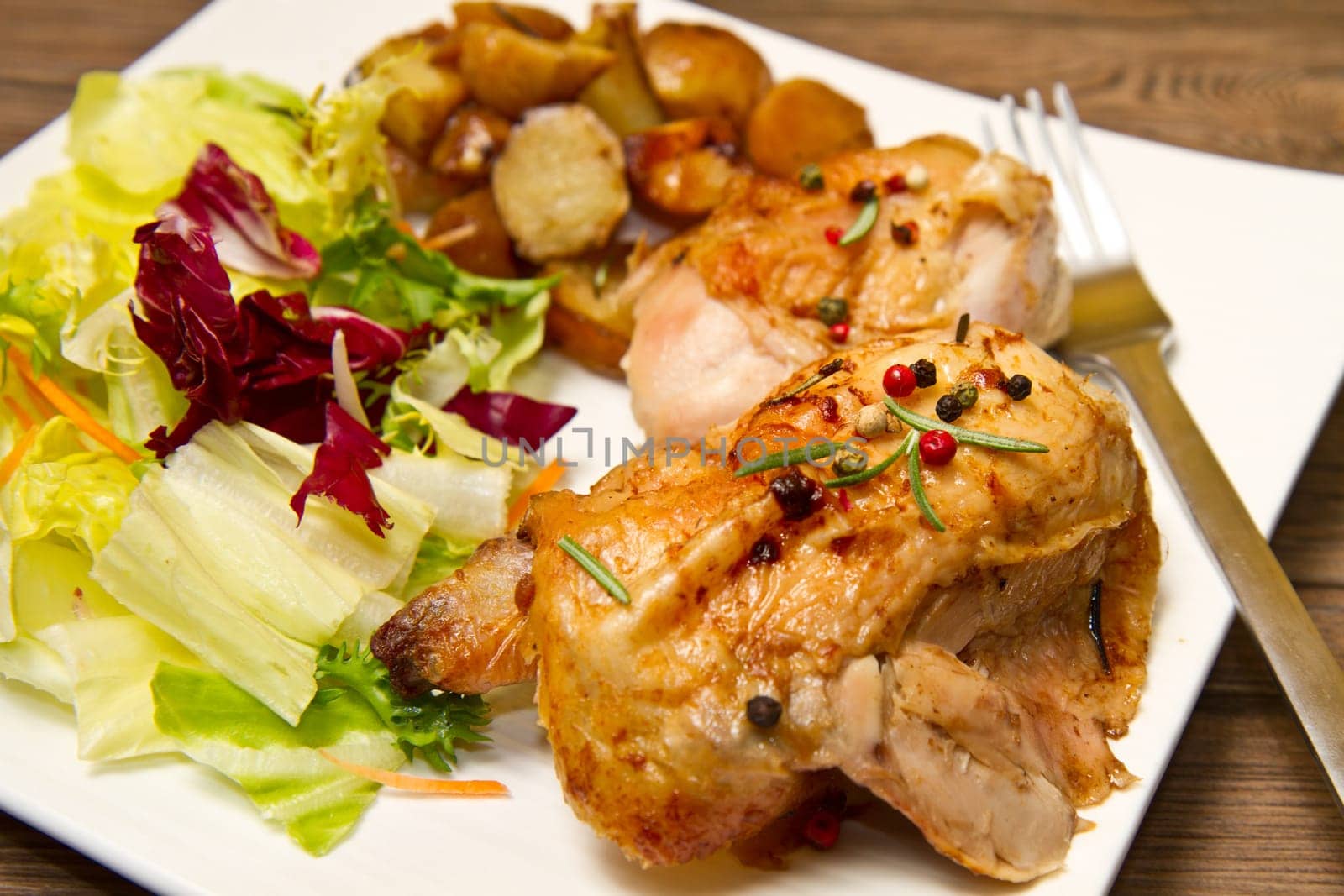 Roast chicken with salad and potatoes