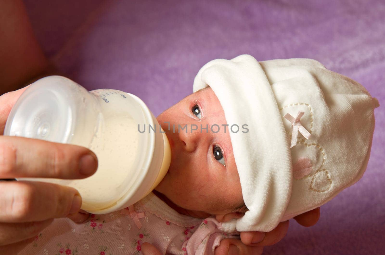 baby eating from a bottle