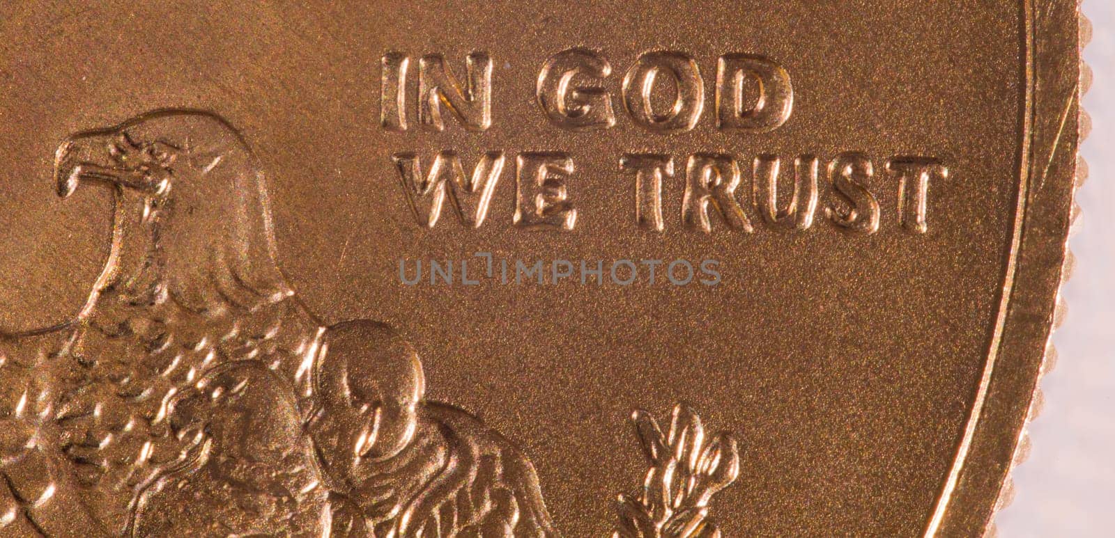 Gold Eagle one ounce coins with macro shot of the engraving of In God We Trust