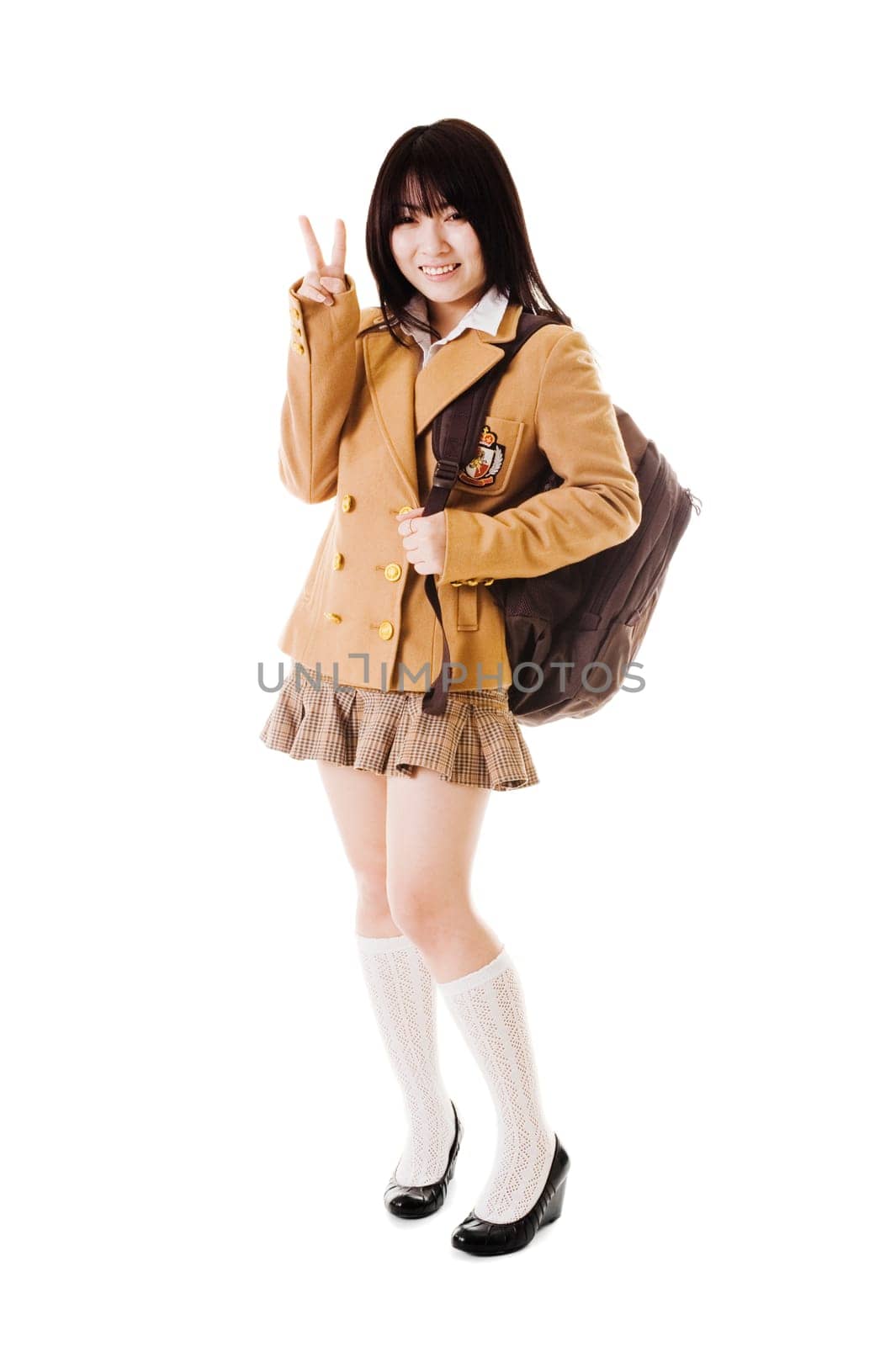 Female Chinese student wearing a backpack on a white background showing a peace sign.